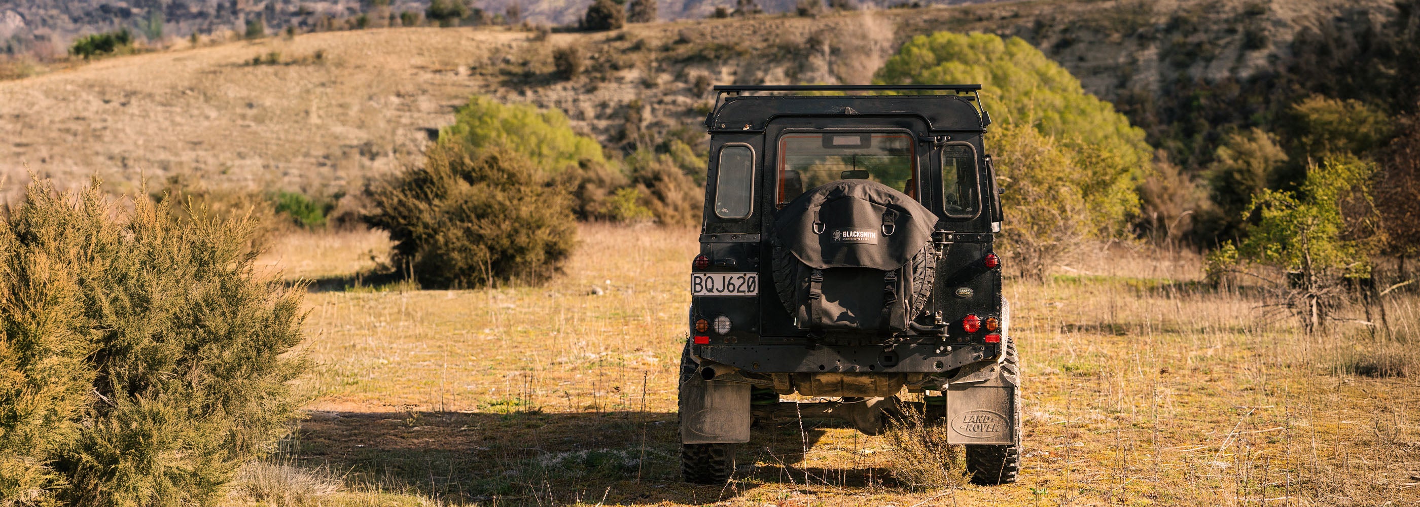 Land Rover Defender in a field with a Australian Made 4WD Wheel Bag